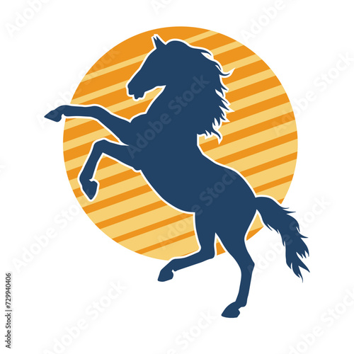 Silhouette of a horse standing on two hind legs. Silhouette of a stallion lifting front legs.