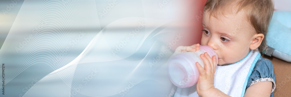 Baby girl drinking milk from bottle; panoramic banner Baby girl drinking milk from bottle; panoramic banner