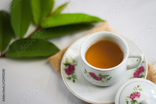 Guava leaf tea in a white cup isolated on White background, herbal drink for diarrhea and cholesterol.selective focus.