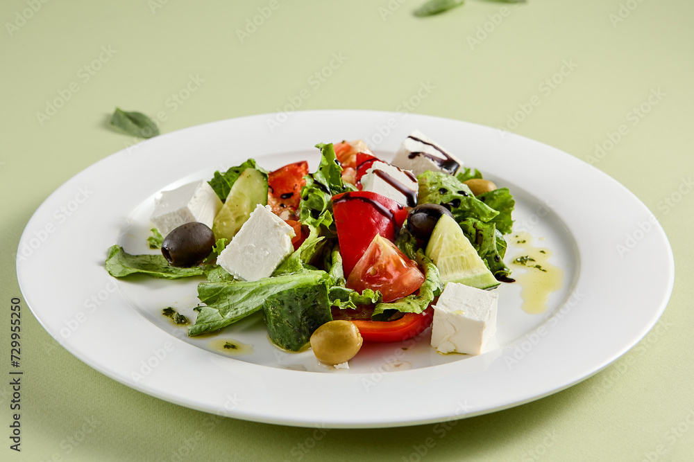 Classic Greek Salad with Feta Cheese and Fresh Vegetables on White Plate Classic Greek Salad with Feta Cheese and Fresh Vegetables on White Plate