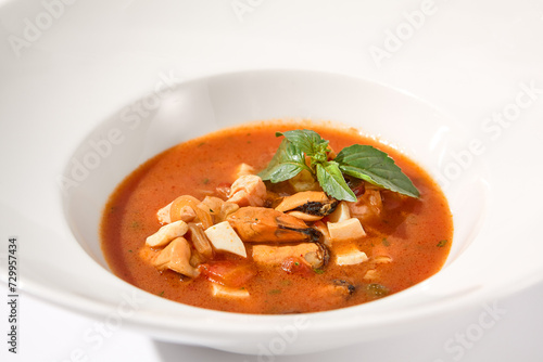 Classic Italian style tomato soup with seafood on white, suited for gourmet blogs and cookbook illustrations