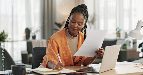 Black woman in home office, documents and laptop for research in remote work, ideas and thinking. Happy girl at desk with computer, writing notes and online search in house for freelance networking.
