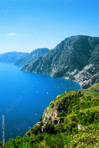 Amalfi Coast, Positano, Peninsula of Sorrento, Campania, Italy. View from Path of the Gods, Sentiero degli Dei. Town Positano on the right. Island Capri in the background.