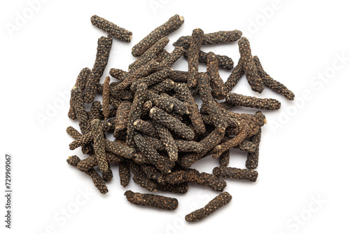 A pile of Dry Organic Long pepper (Piper longum) fruit, isolated on a white background. Top view photo