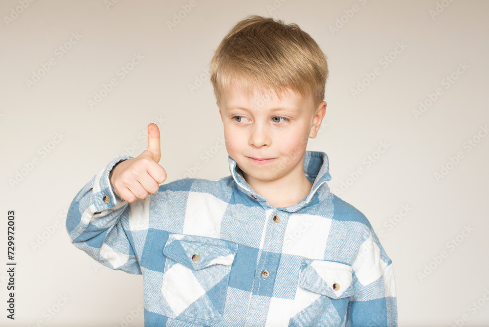 boy showing thumbs up boy showing thumbs up