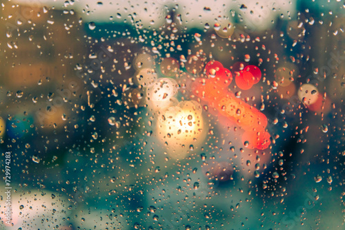 rain on the window surface and traffic bokeh background