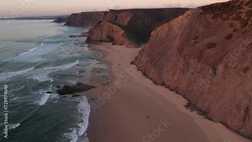 Europe aerial drone ocean beach view, Praia da Cordoama, Algarve, Portugal at sunset