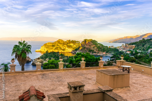 panoramic view from a hotel balcony with terrace to a beautiful sea gulf with sceniv isle and mountains with cloudy sky on background photo