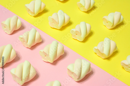 marshmallows in row on the pink and yellow background wallpaper