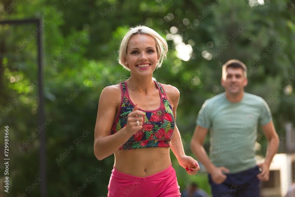 Fototapeta premium Happy young couple running together