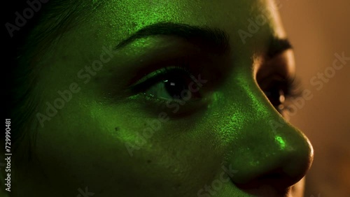 Close up on woman's eyes as she reacts and flinches to something she sees on screen