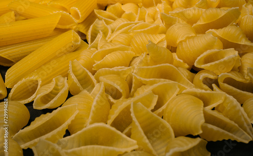 Different types and shapes of dry Italian pasta. Pasta background.