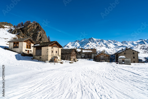 Panoramic view of the Engadine, Lake Sils, and the village Grevasalvas, in winter. © leledaniele