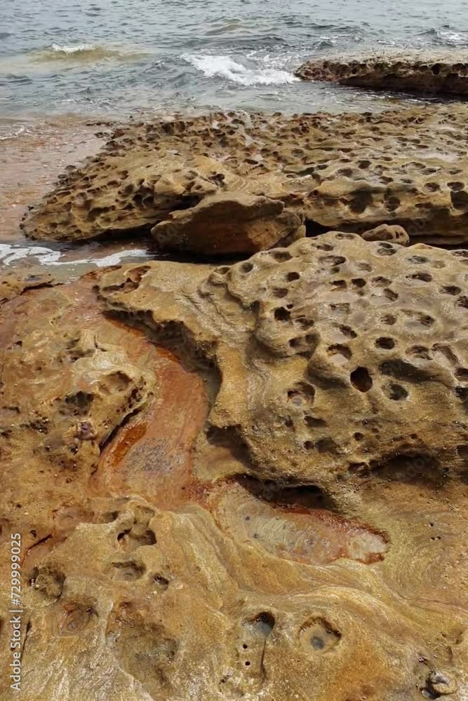 sandstone rock formation with waves at the beach sandstone rock formation with waves at the beach