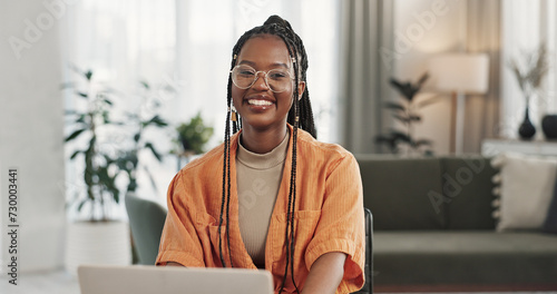 Black woman, portrait in home office and laptop for remote work, social media or blog research with smile in apartment. Happy freelancer at desk with computer for email, website or online in house.