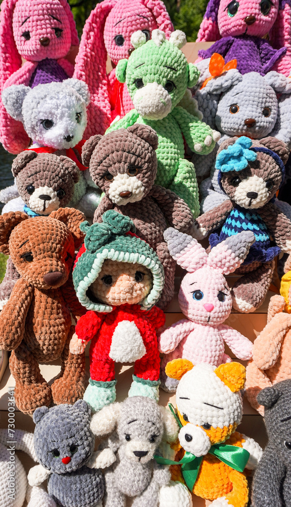 Various knitted colorful soft toys at the outdoors