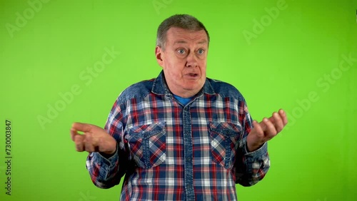 Man twisting finger at temple and shakes his head.