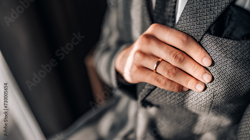 Close-up of a groom getting ready for his wedding day. Wedding ring, groom's hand close up