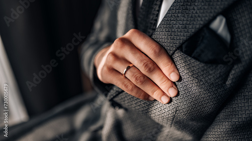 Close-up of a groom getting ready for his wedding day. Wedding ring, groom's hand close up photo