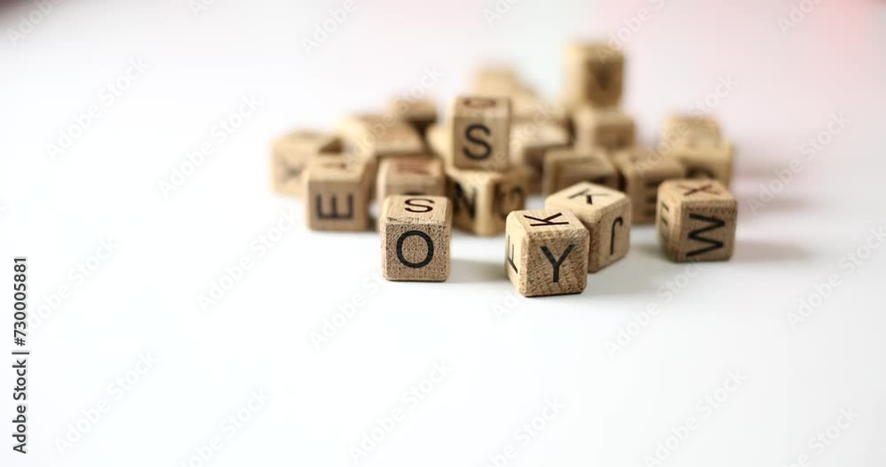 Cubes symbols of alphabet in hands of woman closeup. Languages creativity and learning English Cubes symbols of alphabet in hands of woman closeup. Languages creativity and learning English