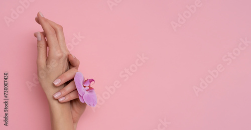 Natural manicure on pink background.