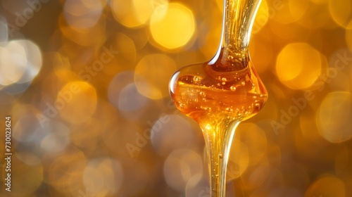 Honey dripping. Close up, honey dipping from the wooden honey spoon.