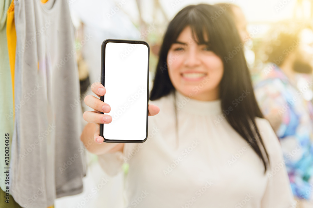 blurred background woman holding mobile phone with blank screen