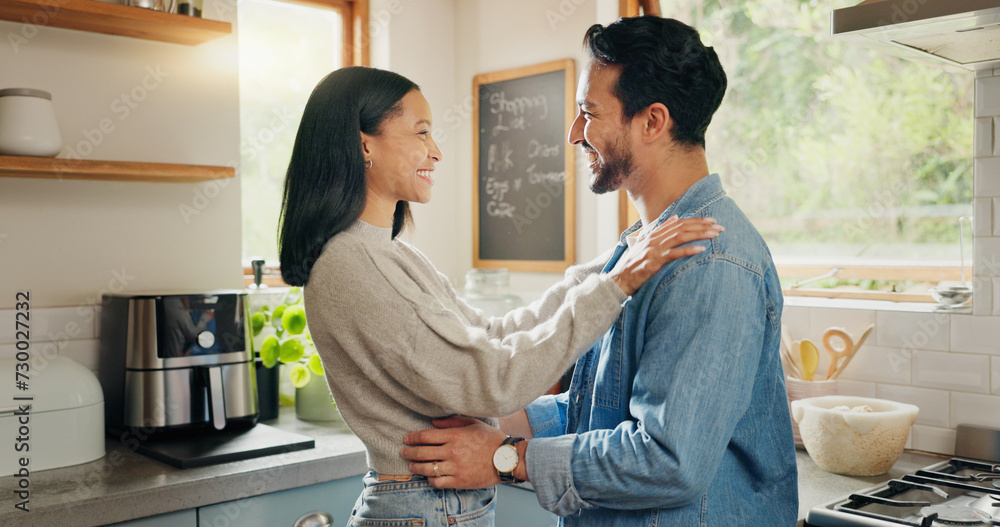 Fototapeta premium Hug, happy and couple in a kitchen bonding, intimate and talking in their home together with intimacy. Love, face and woman embrace man with smile, care and sharing romantic moment and conversation