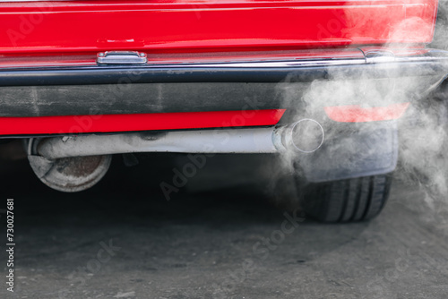 closeup old car rear exhaust pipe with smell smoke carbon monoxide bad air pollution lung disease