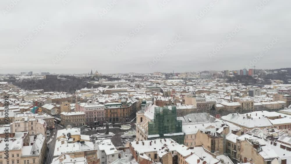 Aerial View of a Wonderful Atmospheric Winter City. Drone Shot of the Charming Ancient Snow Covered Old City Center. Touristic Place. Traveling. Historical Places Concept Aerial View of a Wonderful Atmospheric Winter City. Drone Shot of the Charming Ancient Snow Covered Old City Center. Touristic Place. Traveling. Historical Places Concept