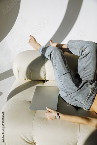 The girl is holding a laptop on a light background