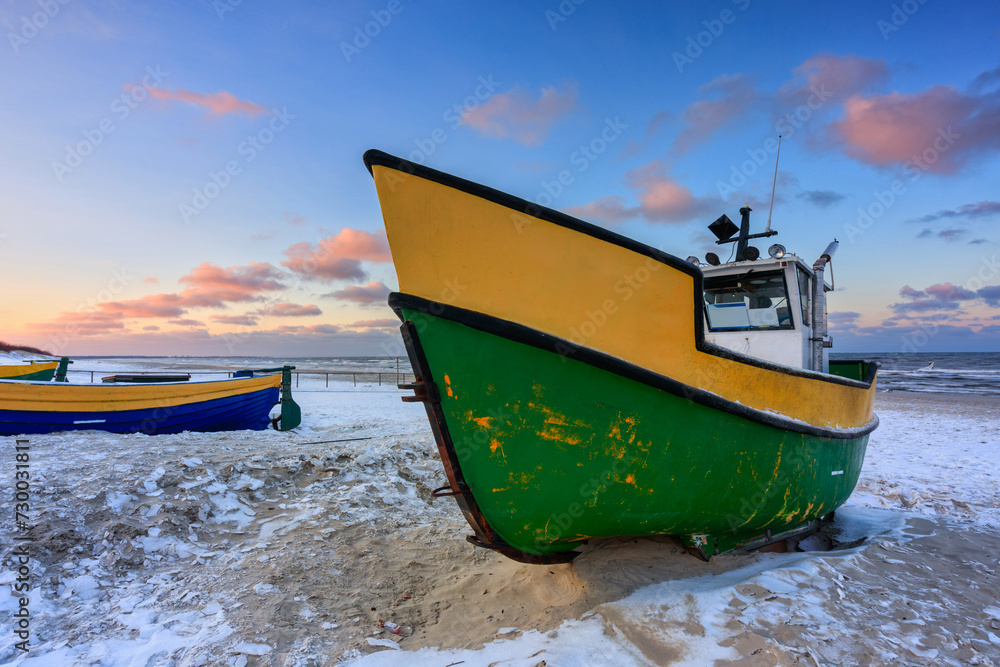 Fototapeta premium Fishing boats on the Baltic Sea beach in Jantar at winter. Poland