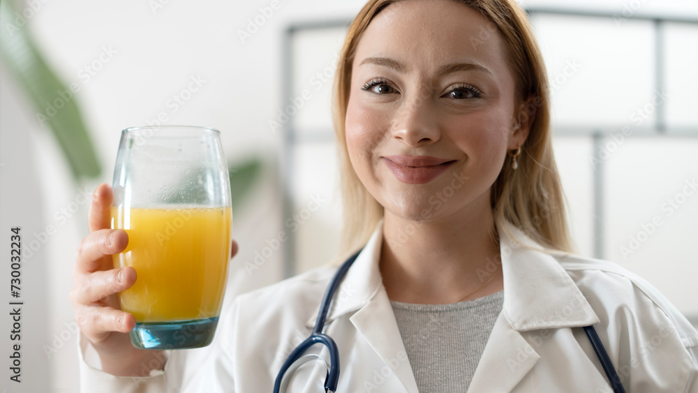 young dietitian doctor drinking orange juice young dietitian doctor drinking orange juice