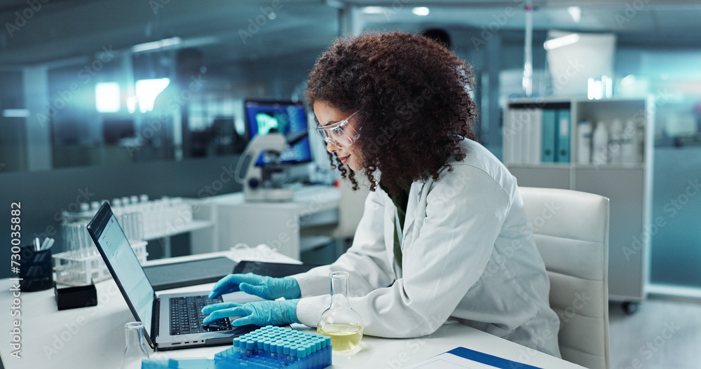Scientist, woman and typing on laptop with test tube for chemistry, research or experiment at lab. Science, computer and serious medical professional in development of cure, biotechnology or study Scientist, woman and typing on laptop with test tube for chemistry, research or experiment at lab. Science, computer and serious medical professional in development of cure, biotechnology or study