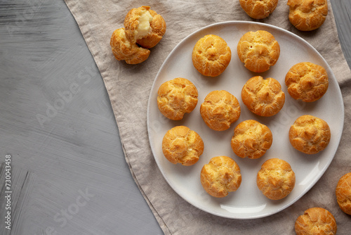 Homemade Mini Cream Puffs on a Plate, top view. Flat lay, overhead, from above. Copy space.