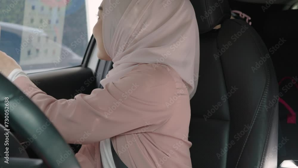 Beautiful Asian Muslim woman pay for food or drinks via smart phone using barcode reader scanning barcode by driving through or drive thru. headscarf. Contactless payment. Beautiful Asian Muslim woman pay for food or drinks via smart phone using barcode reader scanning barcode by driving through or drive thru. headscarf. Contactless payment.