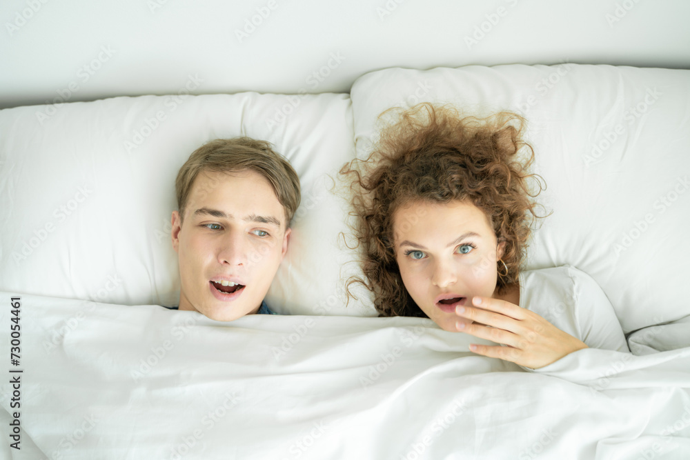 Couple morning wake up together on white bed Couple morning wake up together on white bed