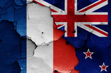flags of France and New Zealand painted on cracked wall