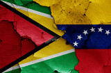 flags of Guyana and Venezuela painted on cracked wall