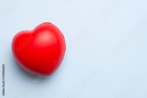 red heart shape on colored background. minimal concept top view with copy space