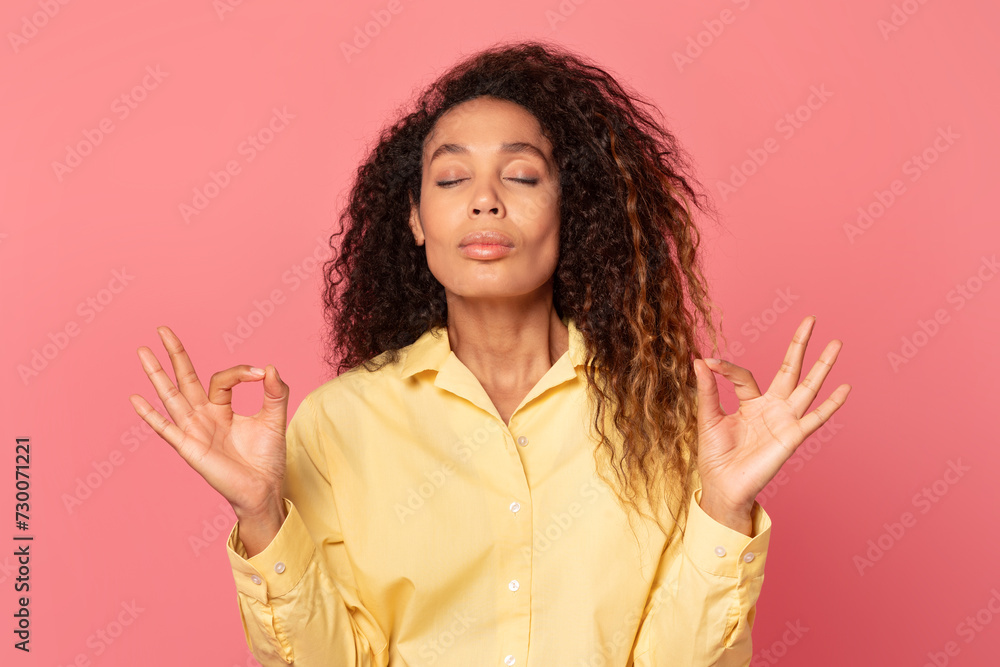 Relaxed african american woman doing yoga gesture Relaxed african american woman doing yoga gesture