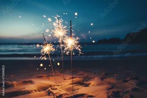 Sparklers on the beach at sunset.