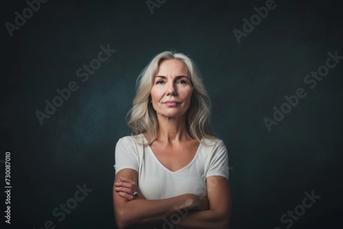 Confident Middle-Aged Woman Shines Amidst A Dramatic Dark Setting