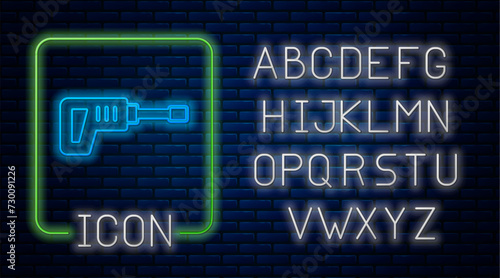 Glowing neon Electric rotary hammer drill machine icon isolated on brick wall background. Working tool for construction, finishing, repair work. Neon light alphabet. Vector