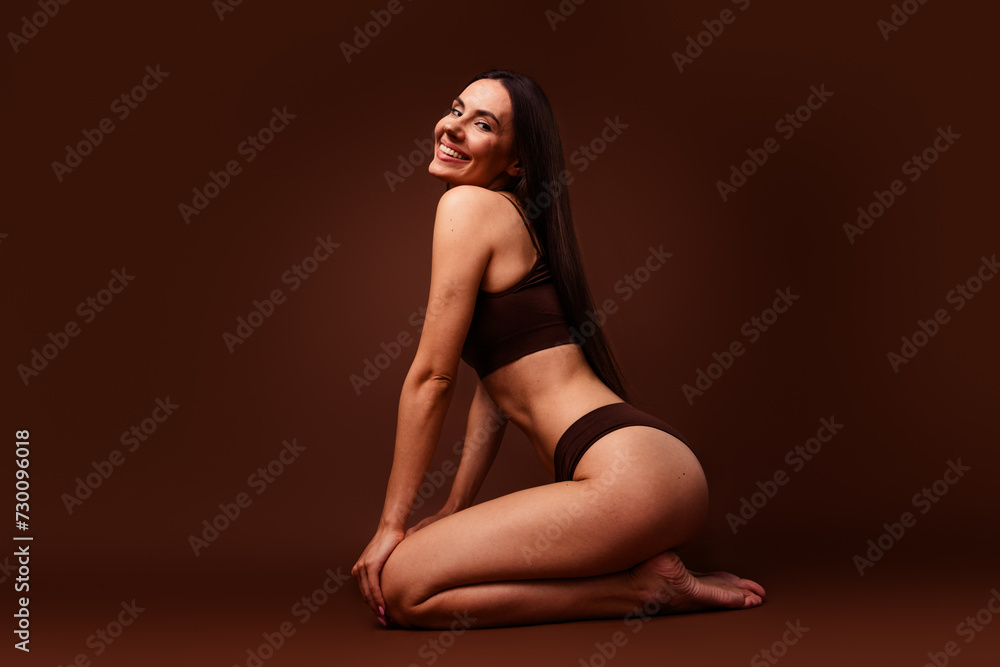 Full size photo no retouch of attractive woman against body shaming sit floor dressed stylish underwear isolated on brown color background