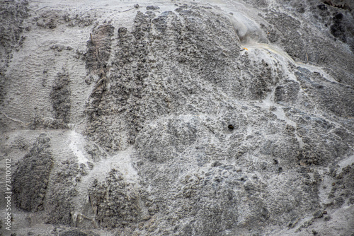 gray stone texture in rotorua geyser in new zealand with water