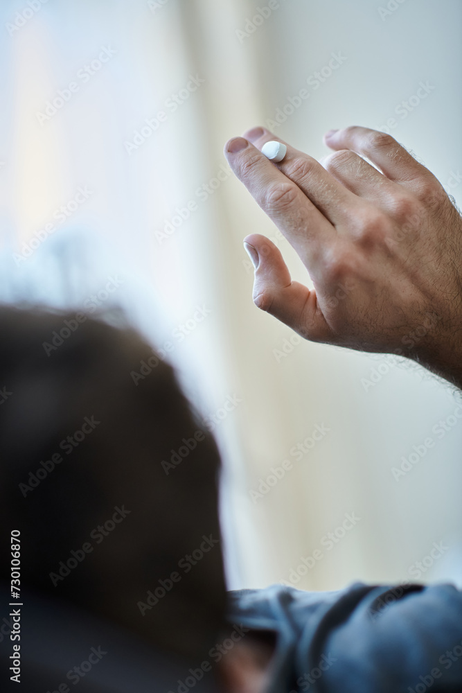 back view of depressed man taking pills during depressive episode, mental health awareness back view of depressed man taking pills during depressive episode, mental health awareness