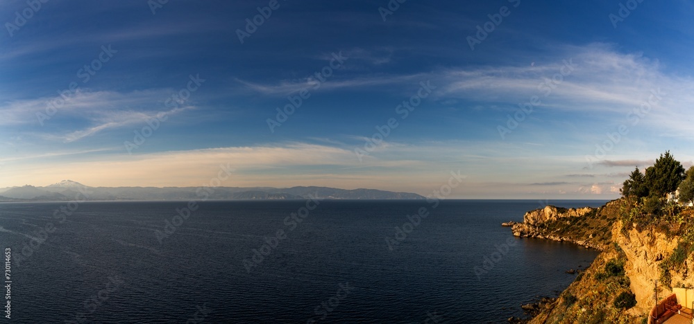 view of the Capo Milazzo peninsula in warm morning light view of the Capo Milazzo peninsula in warm morning light