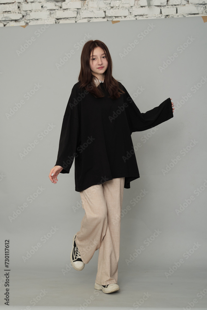 Girl with open arms, her casual stance suggests ease and comfort. It's a modern take on relaxed teen fashion and attitude. Girl with open arms, her casual stance suggests ease and comfort. It's a modern take on relaxed teen fashion and attitude.