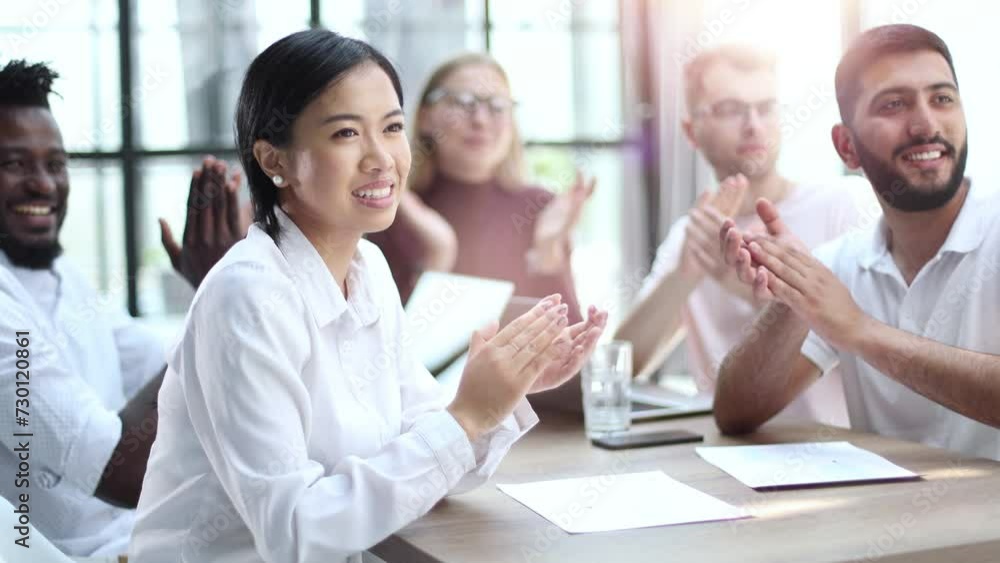 Co-workers applauding their manager at a meeting Co-workers applauding their manager at a meeting